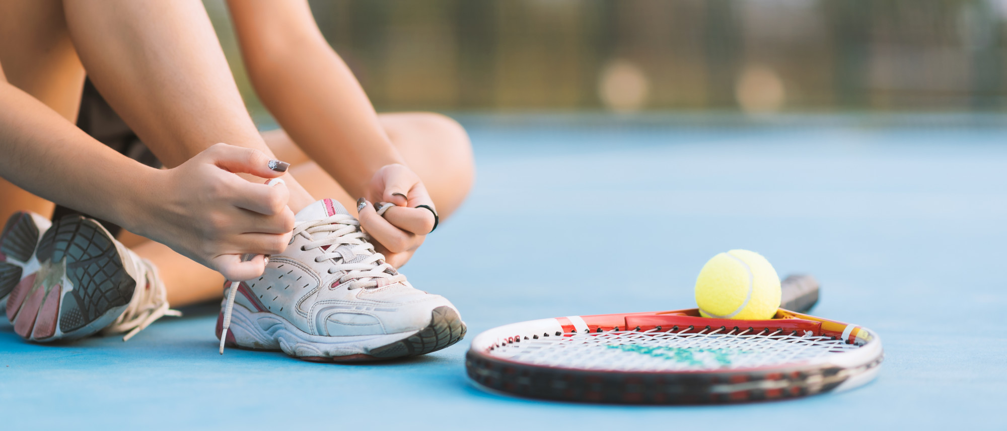 woman tying tennis shoe